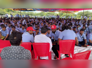 Workers of a Samsung facility speak with their union leader E Muthukumar during the strike.