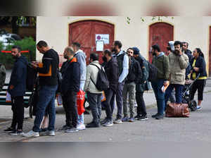 FILE PHOTO: Migrants queue at the arrival centre for asylum seekers at Reinickendorf district in Berlin