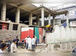 Mandi: An alleged illegal portion of a mosque being demolished by the mosque man...