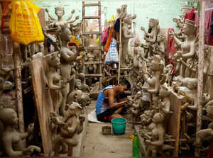 Artisan prepares idols inside a workshop ahead of the Durga Puja festival in Kolkata