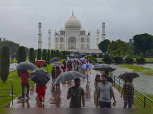 Agra: Tourists visit the Taj Mahal amid rain, in Agra. (PTI Photo)(...