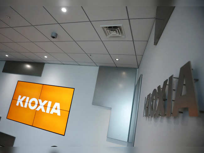 FILE PHOTO: Japanese chipmaker Kioxia's logo and promotional video on a screen are pictured at its headquarters in Tokyo