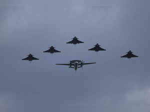 Five Rafale jet fighters escort an Hawkeye 4F during the aerial Bastille Day par...