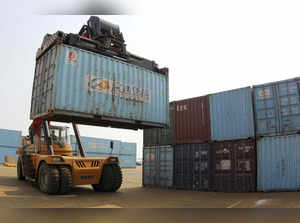 A forklift transfers a shipping container for export at a port in Lianyungan