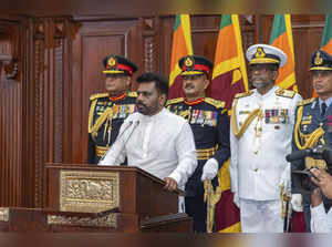 Commanders of the security forces stand behind as Sri Lanka's new president Anur...