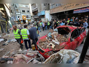 People gather at the site of an Israeli strike in Beirut's southern suburbs