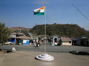 An Indian national flag flies next to an immigration check post on the India-Myanmar border in Zokhawthar village