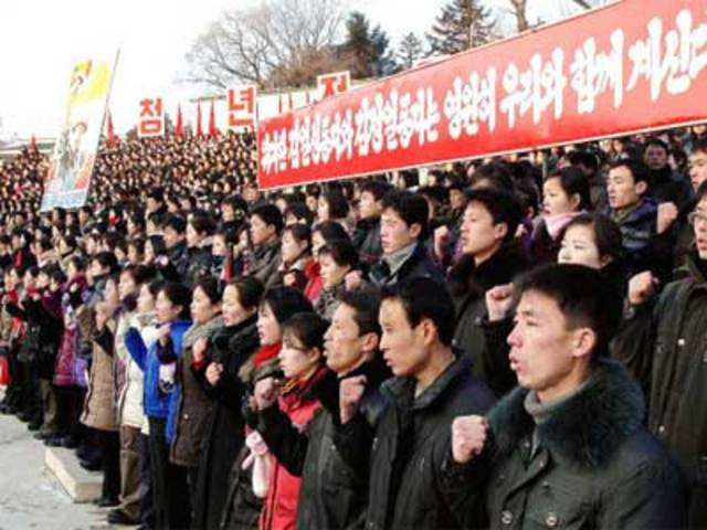 North Koreans hold a rally