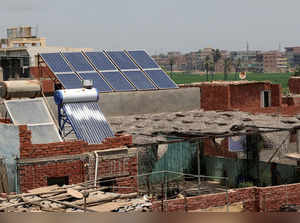 Electric solar panels sit on a roof of Al-Basaysa village, in Sharqiya