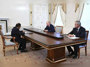 Russian President Vladimir Putin, center, accompanied by Russian Security Counci...