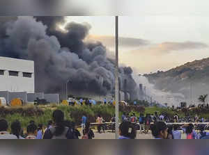 **EDS: SCREENGRAB VIA PTI VIDEOS** Hosur: People gather near a chemical godown o...