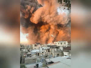 Smoke rises after explosions, in Beirut