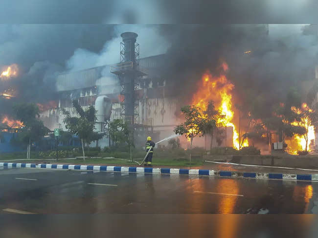 Hosur: A fireman douses a fire breaking out at a chemical godown of the electron...