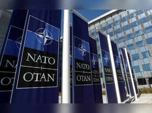 Banners displaying the NATO logo are placed at the entrance of new NATO headquarters during the move to the new building