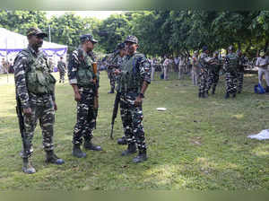 Jammu: Security forces personnel stand guard near an EVM distribution centre ahe...