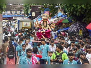 Mumbai: Devotees carry an idol of Goddess Durga to the pandal ahead of Navratri ...