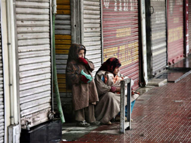 Strike: A Kashmiri woman waits for a transport