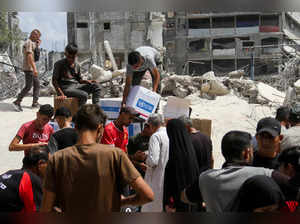 FILE PHOTO: Palestinians gather to receive aid, in Jabalia, northern Gaza Strip