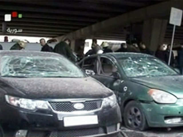 Cars damaged after an explosion in Maidan district