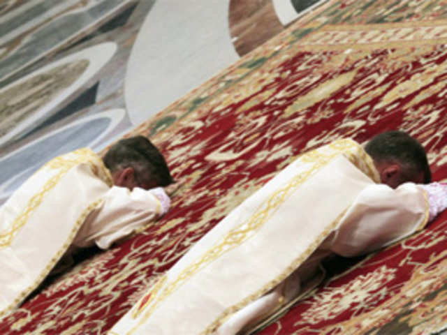 Newly ordained bishops lie in front of Pope Benedict XVI