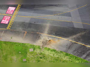 Aerial view taken from a helicopter shows a crater from an explosion after likely WW2-era bomb exploded, on a taxiway at Miyazaki Airport