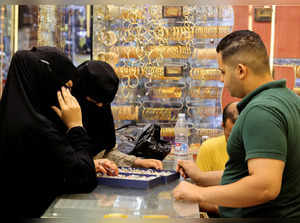 People shop for fake gold called 'Chinese gold', a cheaper alternative to the precious metal, for people to wear during special occasions, at the Khan el-Khalili