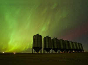 The aurora borealis, also known as the northern lights, light up the sky over a farmer's grain bins near Herronton