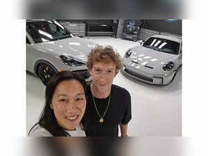 Facebook co-founder Mark Zuckerberg with wife Priscilla Chan taking delivery of new Porsches