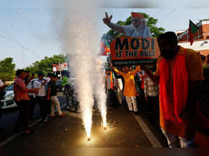 Bharatiya Janata Party (BJP) supporters celebrate outside the BJP headquarters, as the BJP leads in the election results in the northern state of Haryana, in New Delhi