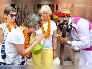 Bikaner, Sep 27 (ANI): A Rajasthani folk artist welcomes a foreign tourist on th...