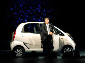 FILE PHOTO: India's Tata Group Chairman Tata steps out from the company's new "Nano" car during its launch in New Delhi