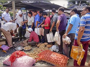 Balurghat: People queue up to purchase potatoes and onions at subsidized rates f...