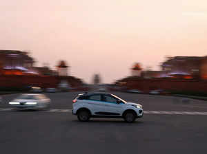 An electric vehicle is driven on the road near India's Rashtrapati Bhavan Presidential Palace in New Delhi