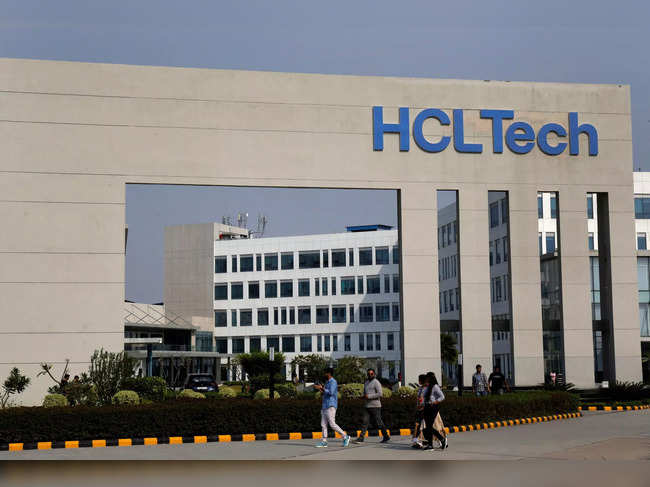 FILE PHOTO: Employees of HCLTech walk inside the office premises on outskirts of Lucknow