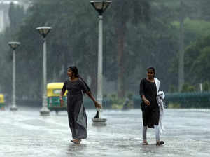 Bangalore, May 03 (ANI): People enjoy their walk as it rains heavily, in Bangalo...