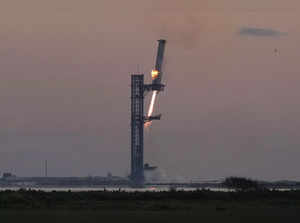 SpaceX's mega rocket booster returns to the launch pad to be captured during a t...