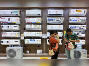 People shop for an air conditioner inside an electronics store in Mumbai