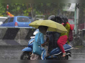 Chennai: People amid rain as the India Meteorological Department (IMD) has issue...