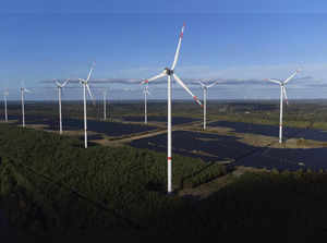 Wind turbines operate at the Klettwitz Nord solar energy park near Klettwitz, Ge...