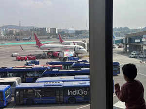 FILE PHOTO: A boy looks at Air India airline passenger aircrafts parked at the Chhatrapati Shivaji Maharaj International Airport in Mumbai