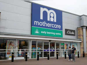 People walk past a Mothercare store in Altricham