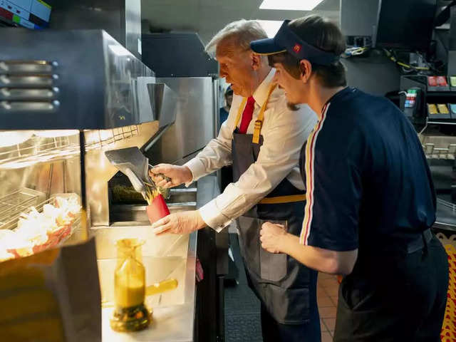 Dons apron and cooks fries