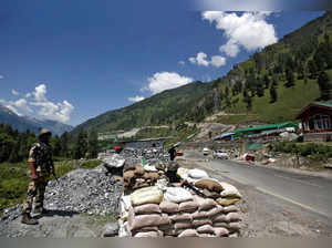 India's BSF soldiers stand guard at a checkpoint along a highway leading to Ladakh, at Gagangeer