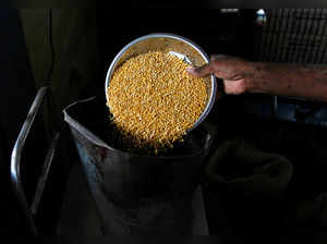 FILE PHOTO: A man weighs lentils inside his shop in the southern Indian city of Chennai