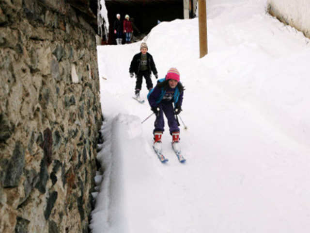Children of Kosovo Muslim minority Gorani play in snow in the village of Krusevo