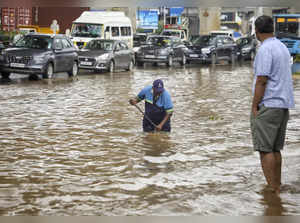 Bengaluru: A Bruhat Bengaluru Mahanagara Palike (BBMP) worker clears the blocked...