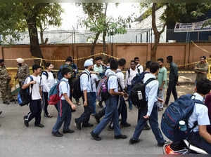 New Delhi, Oct 21 (ANI): School children pass by the blast site near CRPF School...