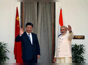 FILE PHOTO: India's PM Modi and China's President Xi wave to the media during a photo opportunity ahead of their meeting at Hyderabad House in New Delhi