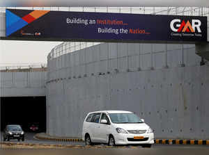 FILE PHOTO: Vehicles cross through an underpass constructed by GMR Infrastructure that connects to the airport in New Delhi