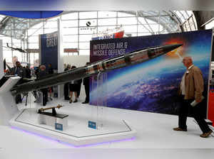 A man looks at a Patriot Advanced Capability (PAC-3) Missile Segment Enhancement (MSE) model by Lockheed Martin at an international military fair in Kielce